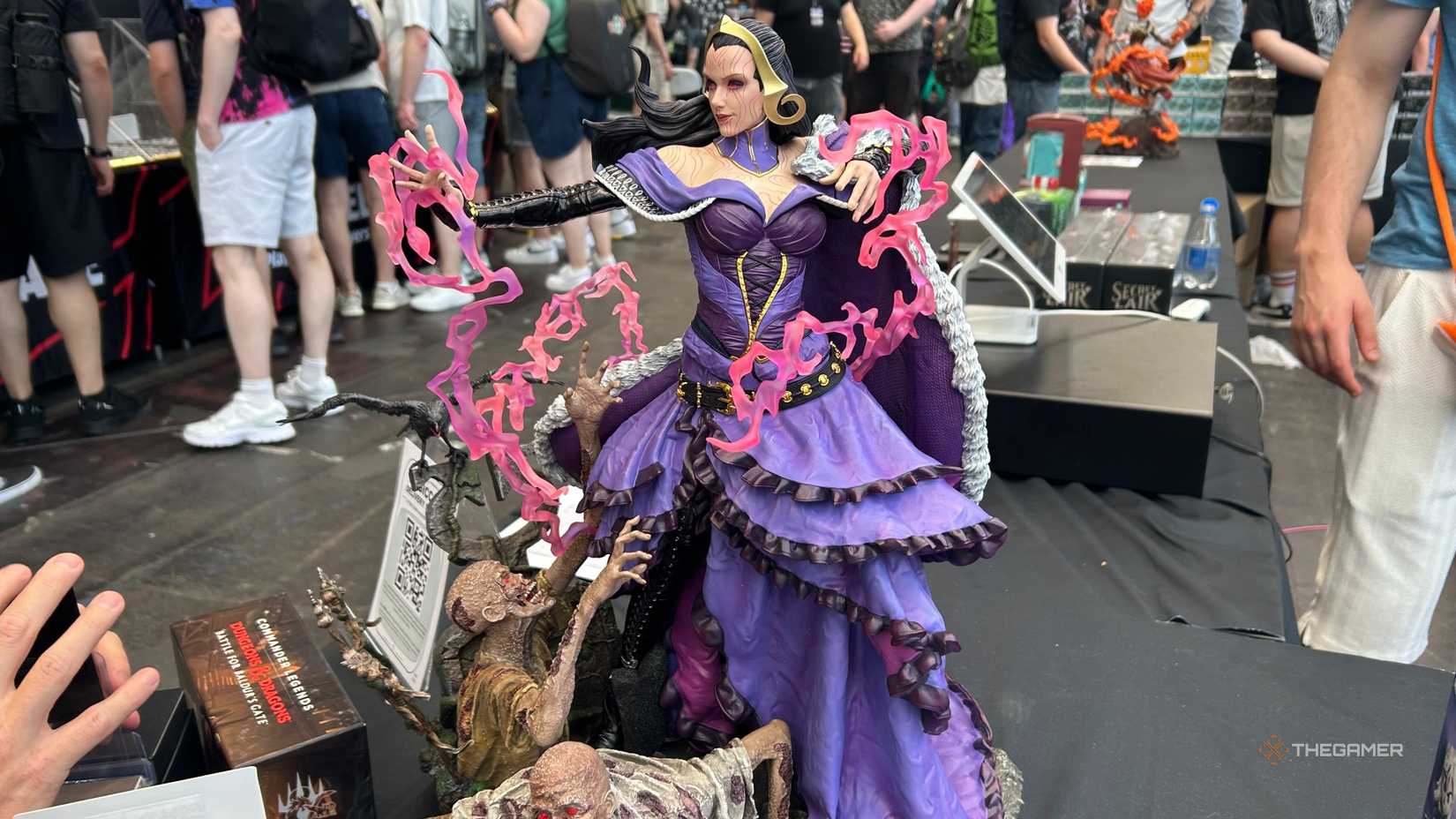 A statue of Liliana Vess casting spells while zombies rise up from her feet.