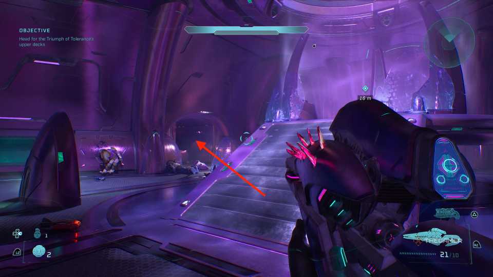 An arrow pointing to a doorway on the other side of a grav lift in a large purple room in Halo Campaign Evolved.