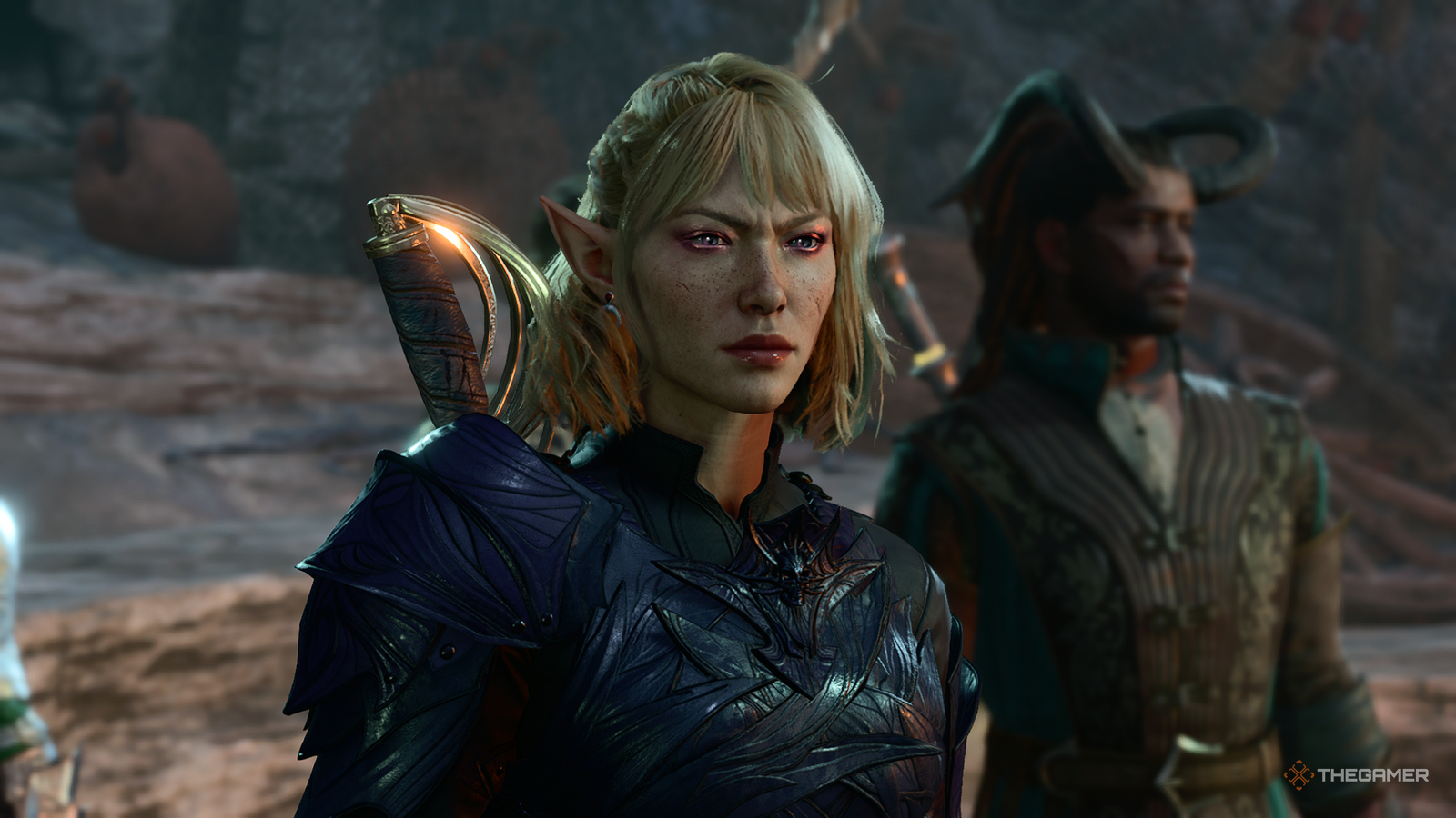 A blonde elven woman with short hair and wearing purple armour in Baldur's Gate 3. Wyll can be seen behind her. 