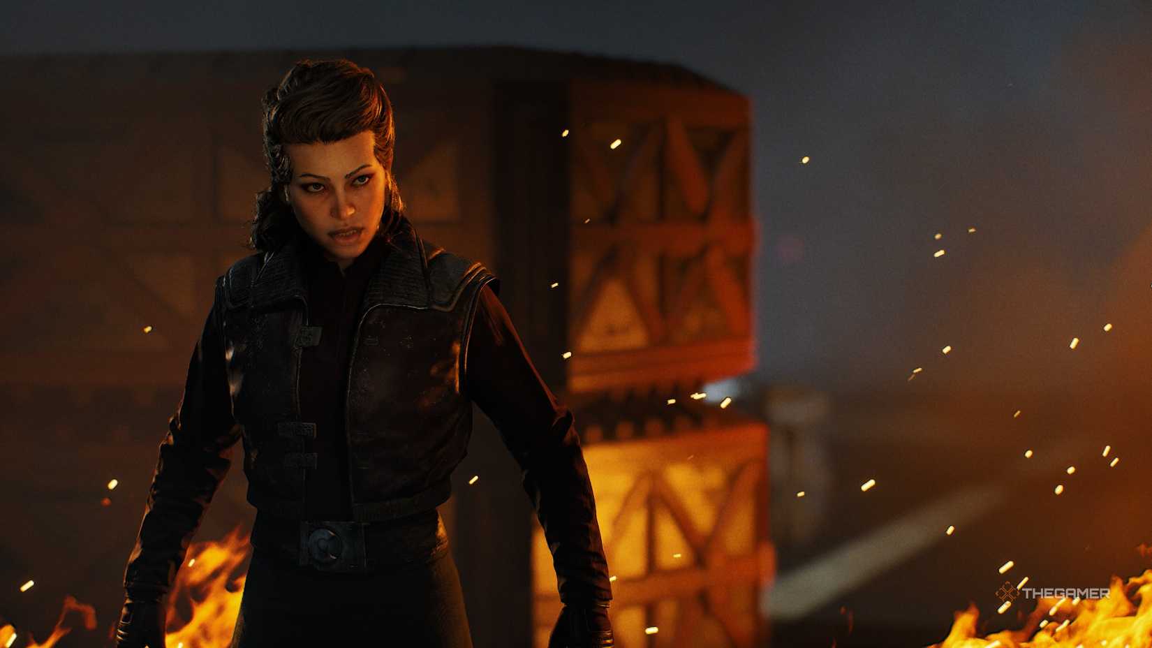Hawks in Star Wars Zero Company. She is a human woman with brown hair, wearing a leather jacket and standing in front of flames