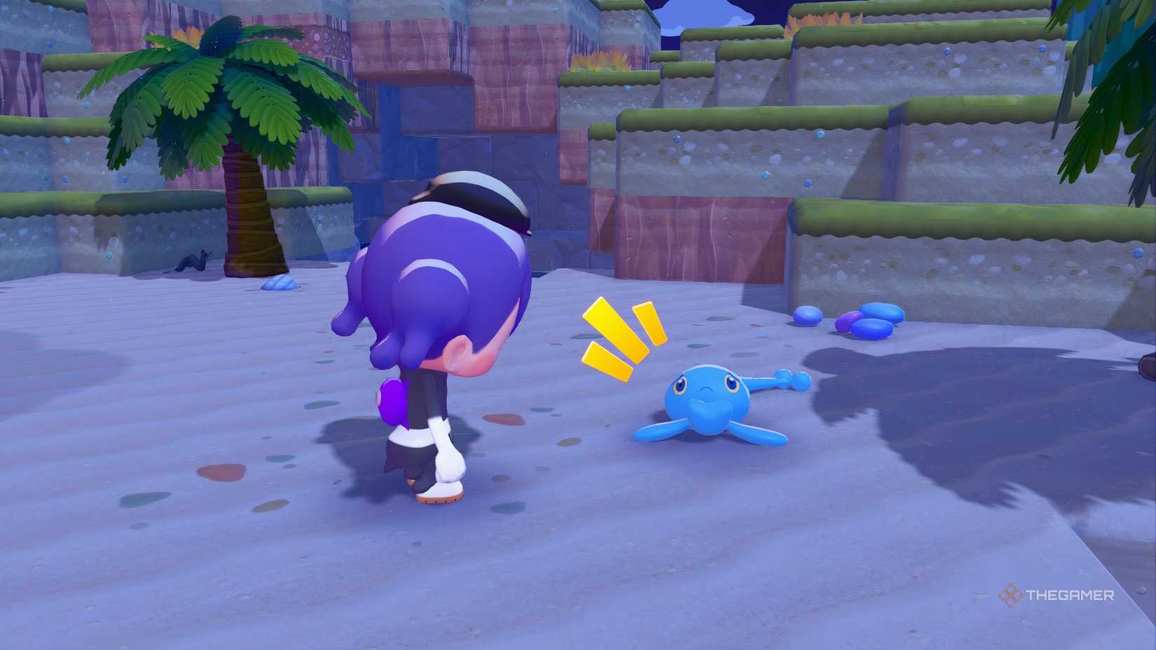 Manaphy laying on the beach with Ditto looking down at it in Pokemon Pokopia.